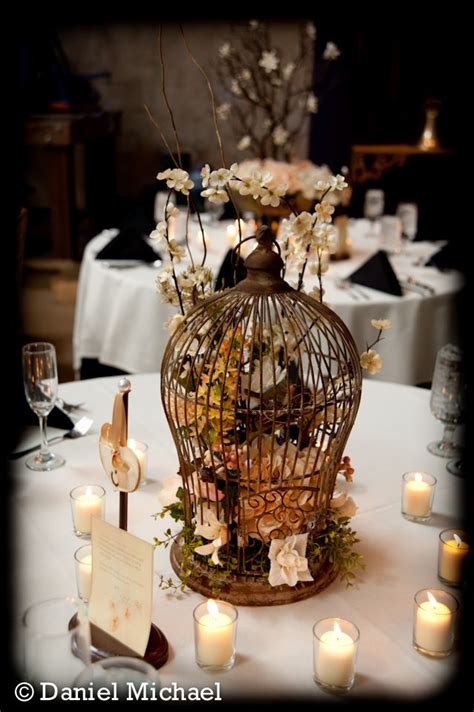 Decorative birdcages with floral or candle arrangements inside and ribbon or tulle embellishments outside could be the elegant touch you're looking for. Cincinnati Wedding Birdcage centerpiece | Wedding Ideas ...