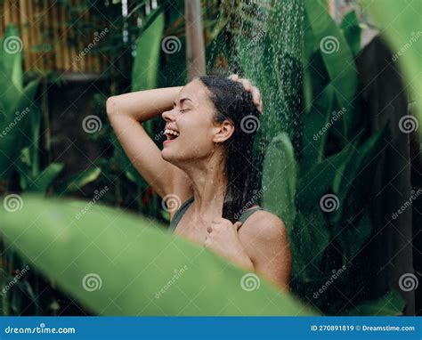 A Woman Takes A Shower And Washes Her Head And Hair Outdoors Closed