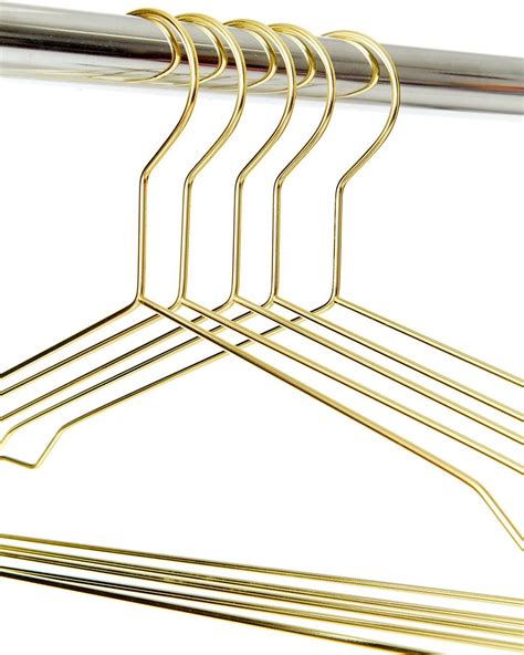 Gold Colored Clothes Hangers On A White Background