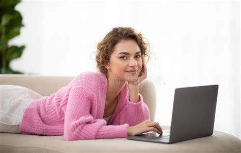 Smiling Female Browsing Internet On Laptop While Relaxing On Couch At Home Stock Image Image