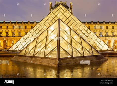 Night View Of Famous Louvre Museum With Louvre Pyramid Paris Stock