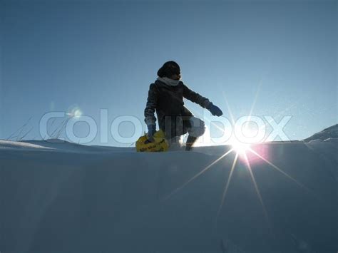 Girl Standing In Deep Snow Pointing At Stock Photo