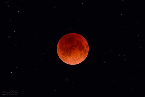 Total Lunar Eclipse With A Super Red Moon Immersed In A Colorful