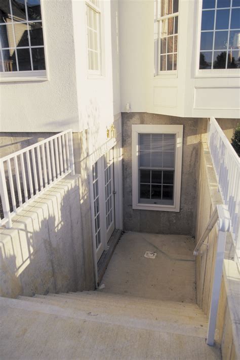 The wide opening allows storage items such as deck and patio furniture, and large items such as pool tables and furniture, to be easily moved in and out of a basement. How to Build a Walkout Basement on Level Land | eHow