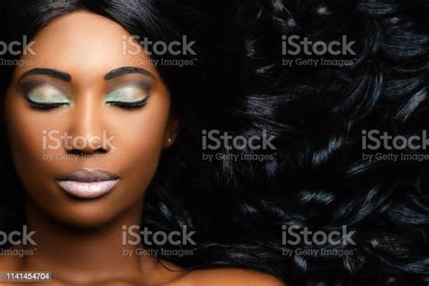 Beauty Portrait Of African Woman Showing Long Hair With Smooth Waves