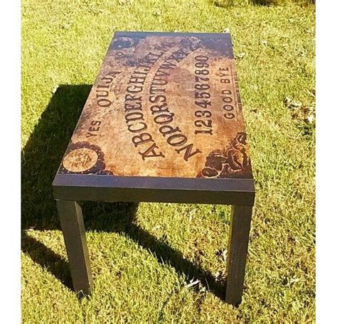 Costing only around $120 to make, you will need pine, steel wool, vinegar, a miter saw, sandpaper, laser printer, screws, pocket hole jig, and polyurethane. Custom Made OUIJA BOARD Coffee Table | aftcra
