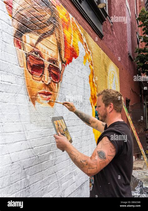 Street Art Artist Painting A Mural On A Wall In Williamsburg Brooklyn