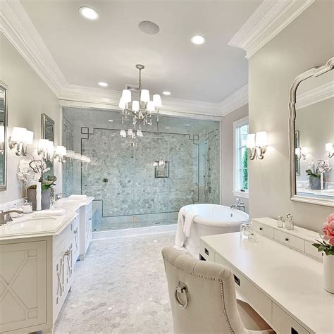 A Large Bathroom With Two Sinks Tub And Chandelier Hanging From The