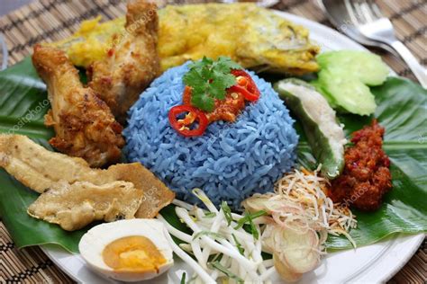 Nasi lemak with sambal ikan bilis (curried dry anchovies), cucumber, chicken curry, pork floss and an eggthe malays were malaysia's. Nasi kerabu, blue color rice salad, malaysian cuisine ...