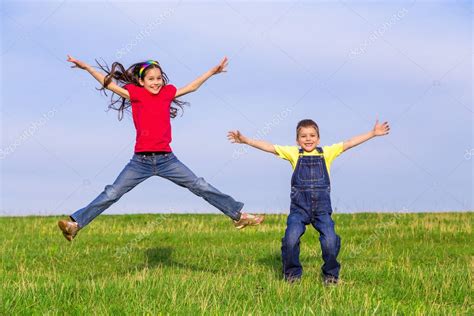 Jumping Kids On Green Field — Stock Photo © Sbworld7 47391589