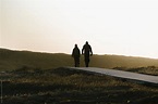 "Silhouette Of Two People Walking Away In To The Distance At Sunset ...