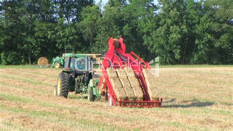 Farmer Square Baling Hay: Royalty-free video and stock footage