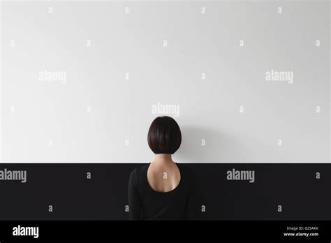 Rear View Of Woman Standing Facing Wall Stock Photo Alamy