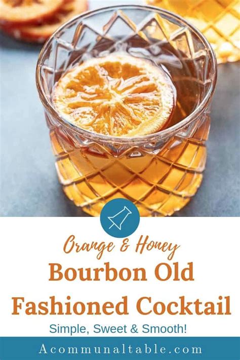 An Orange And Honey Bourbon Old Fashioned Cocktail In A Glass With The