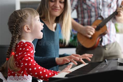 Little Beautiful Girl Sings Song Is Played On Piano Together With Her