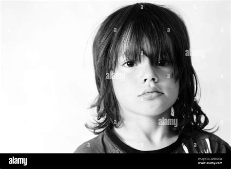 Portrait Of 8 Year Old Boy With Long Hair Looking Sad Head And