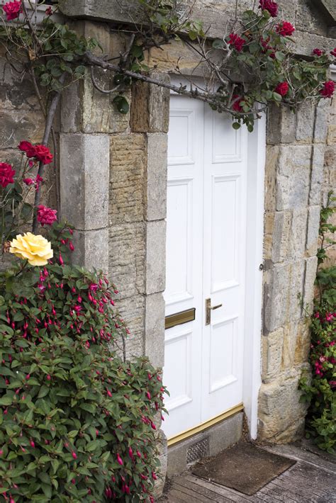 Free Stock Photo 12963 Roses Growing Around Stone Block Cottage Door
