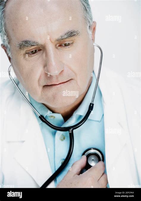 Close Up Of A Male Doctor Examining Himself With A Stethoscope Stock