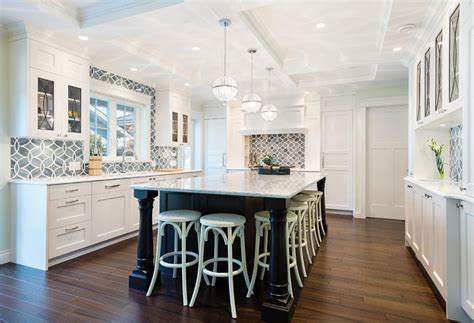 These blue and white tiles have us dreaming of provence and they fit with the pretty periwinkle swirls painted on the adjacent wall. White Kitchen with Blue Gray Backsplash Tile - Home Bunch ...
