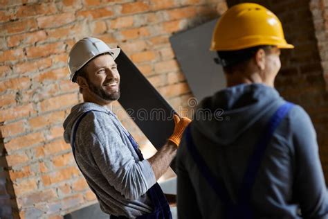 Let Us Help You Cheerful Young Male Builders Wearing Hard Hats Smiling