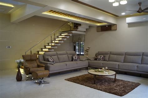 A Living Room Filled With Furniture And A Stair Case In The Middle Of