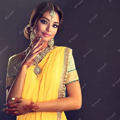 Premium Photo Black Haired Indian Young Woman Dressed In A Posh Yellow Sari Model Dressed In A