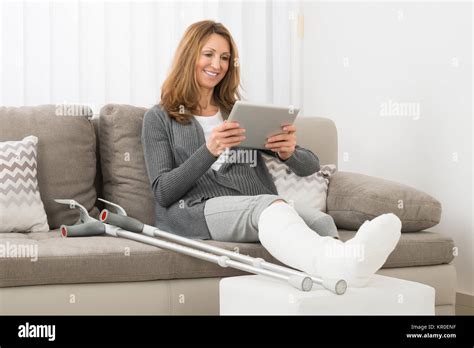 Woman With Fractured Leg Using Digital Tablet Stock Photo Alamy