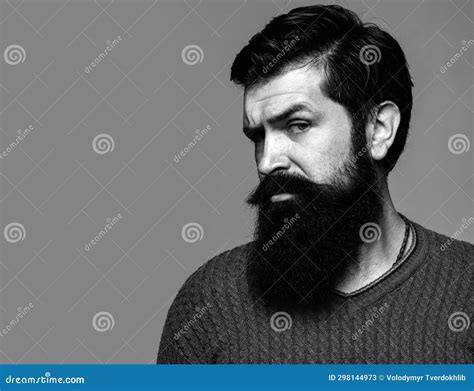 Portrait Of Confident Serious Man Has Beard And Mustache Looks