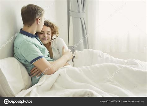 Beautiful Loving Couple Kissing In Bed — Stock Photo © Kritsaya 331309474