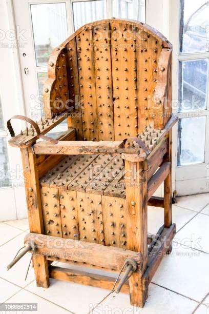 Old Wooden Chair With Spikes For Torture Stock Photo Download Image
