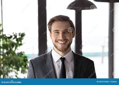 Headshot Portrait Of Smiling Caucasian Businessman Pose At Workplace