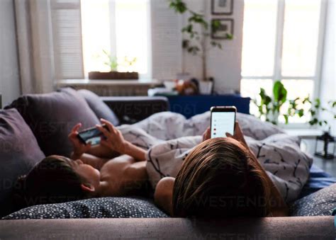 Mother And Son Are Watching Smartphones Stock Photo