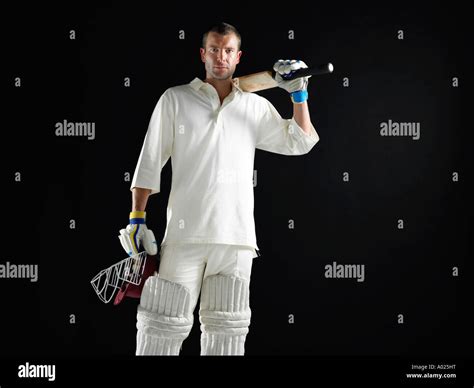 Cricket Player Standing Holding Cricket Bat On Shoulder Stock Photo