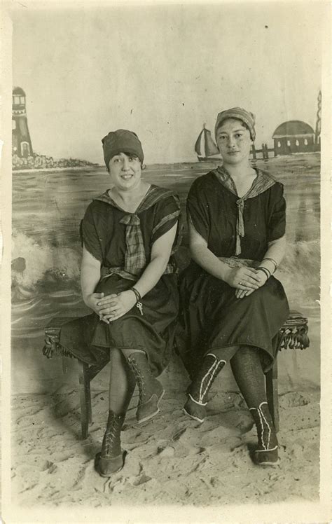 Two Women Sitting Next To Each Other On A Bench In Front Of The Ocean