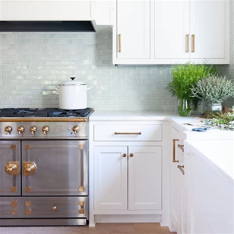 A thin bead of caulk can fill that small gap between cabinets and floors in less than 30 minutes. White cabinets blue tile, inset shaker style cabinets. furniture like feet, quarter round around ...