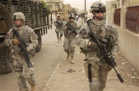 Us Army Soldiers Move Down A Street
