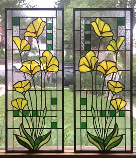 Two Stained Glass Windows With Yellow Flowers On Them