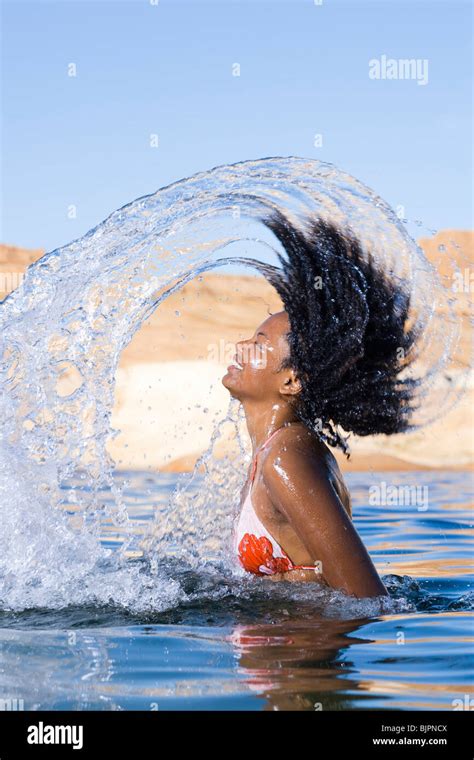 Woman Splashing In Water Stock Photo Alamy