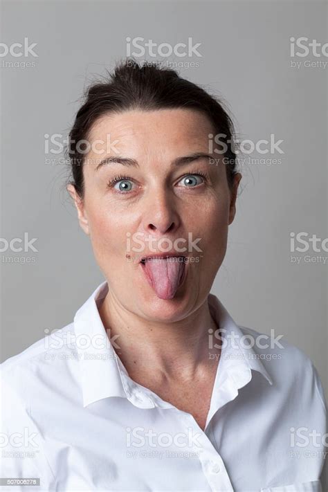 Playful Beautiful Woman Sticking Her Tongue Out For Funny Face Stock