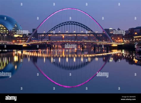 A Night View Of The Tyne Bridge Framed By The Millennium Bridge Stock