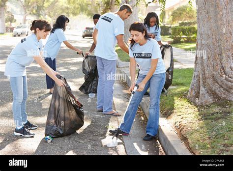 Team Of Volunteers Picking Up Litter In Suburban Street Stock Photo Alamy