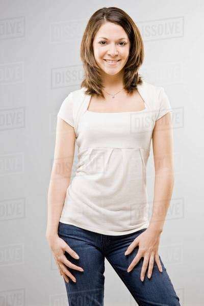 Woman Standing With Hands On Hips Stock Photo Dissolve