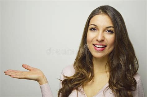 Young Smiling Woman Showing With Open Hand Palm Your Product On White