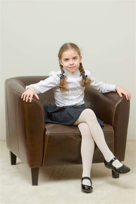 A Little Girl Is Sitting On A Chair Stock Photo Image Of Person