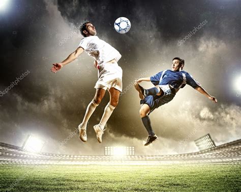 Two Football Players Striking The Ball — Stock Photo © Sergeynivens