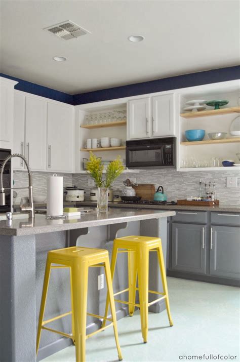 Say goodbye to the stark white kitchens of the past and hello to the mix of colors that define the kitchen trends of the present. Love the white top and grey bottom cabinets. I like the pop of yellow or maybe a teal blue ...