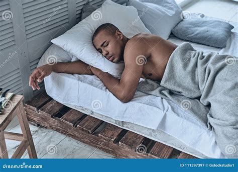 Relaxing At Home Top View Of Young African Man Sleeping While L Stock