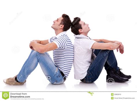 Two Young Casual Men Sitting Back To Back Stock Photo - Image: 23802910