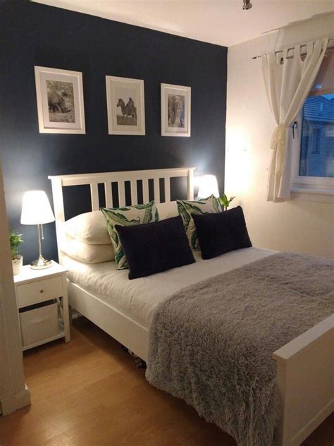 Dark Blue And White Small Double Bedroom With Accents Of Green