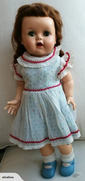 The Doll Is Wearing A Dress And Blue Shoes